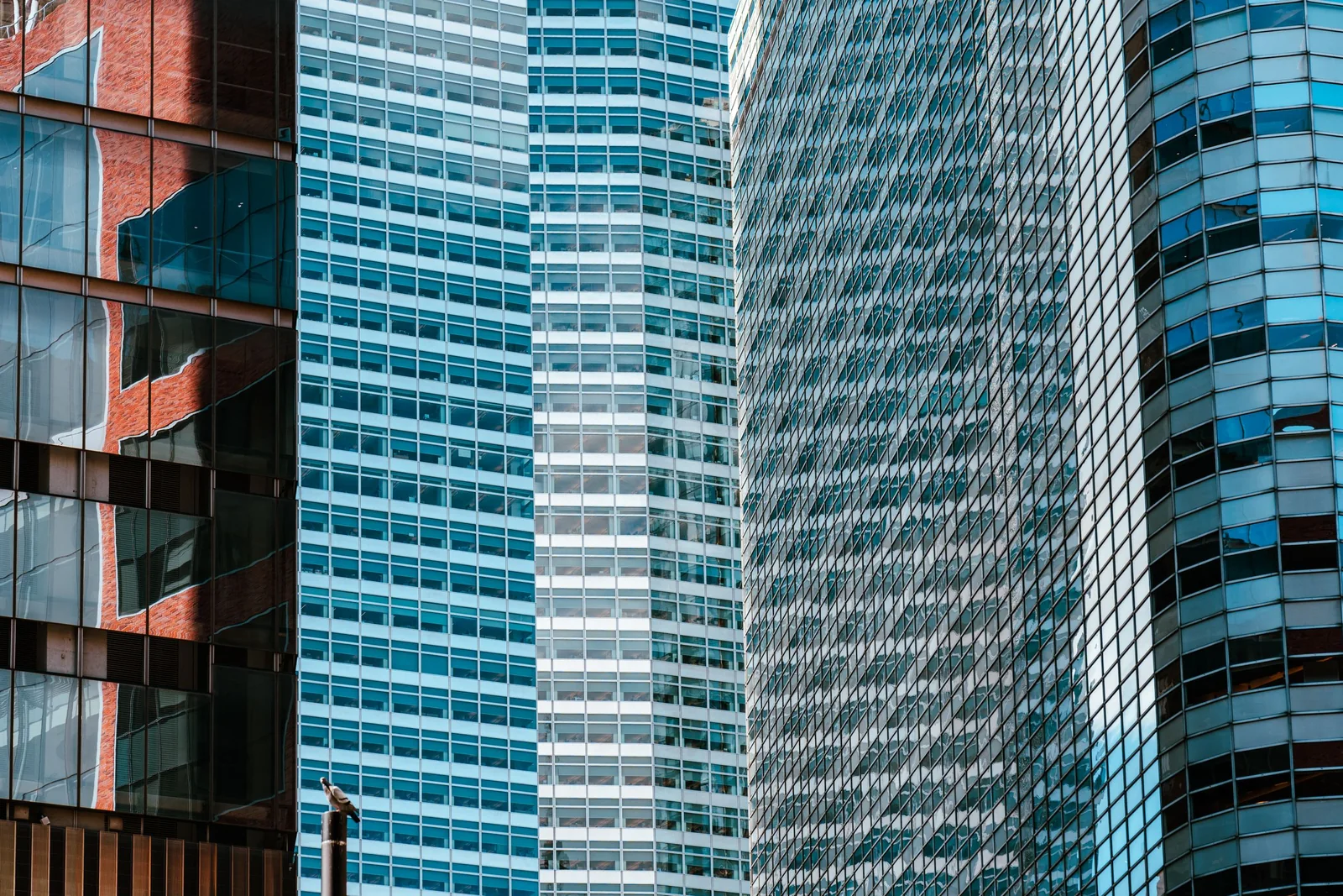 Glass office buildings reflecting the sky
