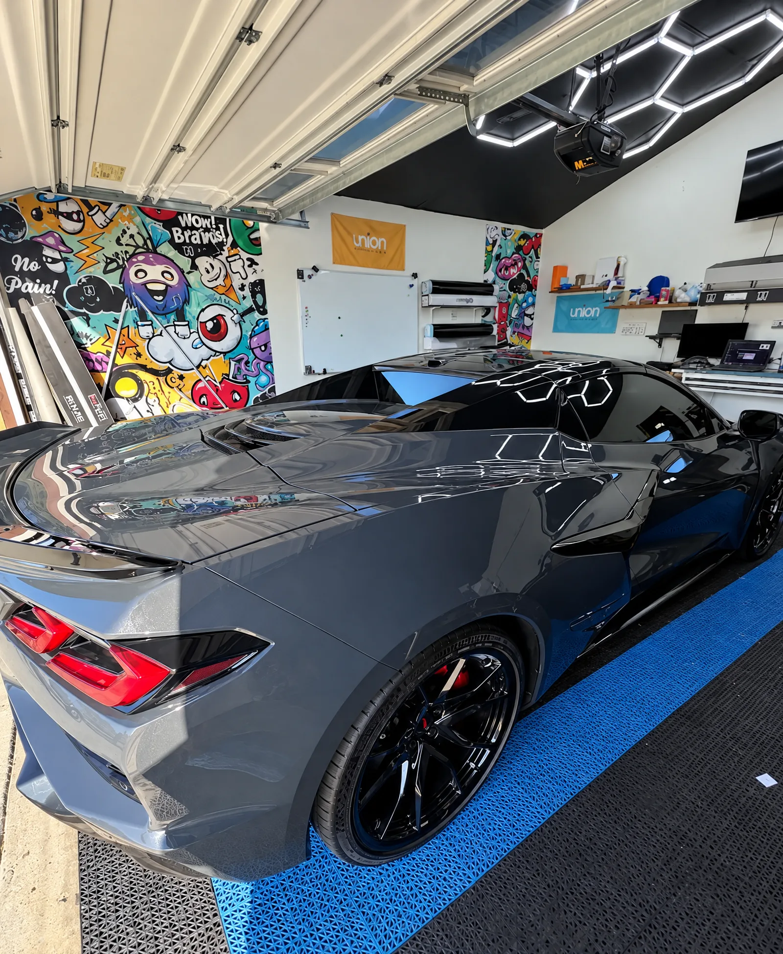A gray Chevrolet Corvette with tinted windows in the Tint-One workshop in Huntington Beach