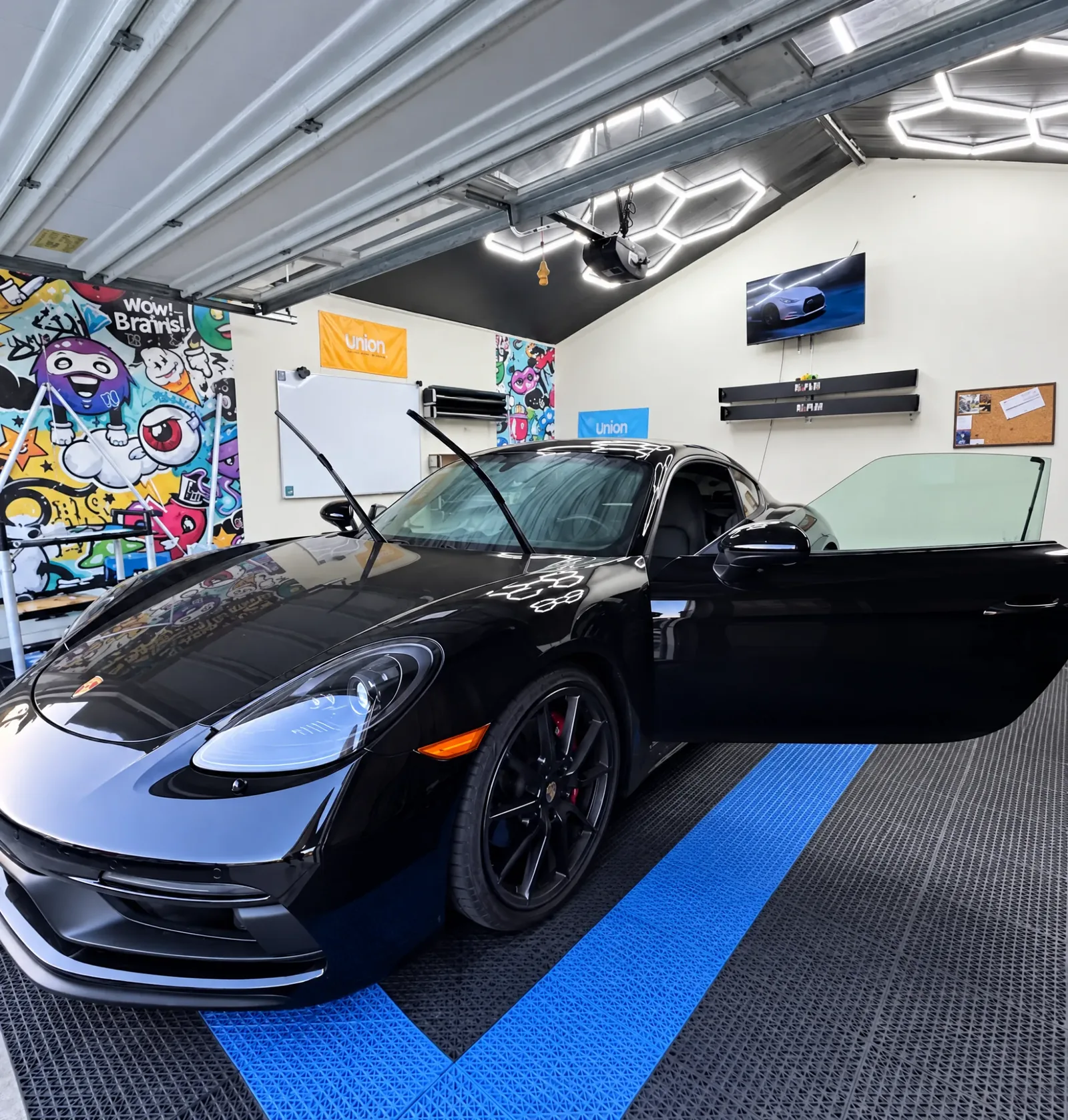 A black Porsche 718 Cayman in the Tint-One workshop in Huntington Beach