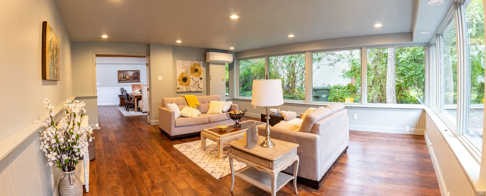 A sunny living room with large windows